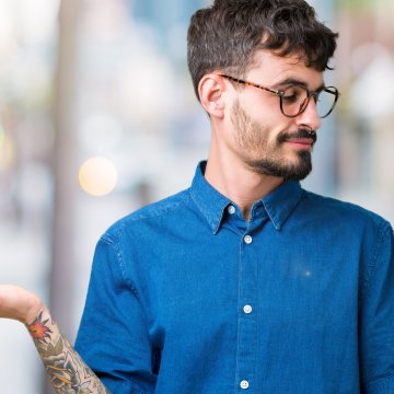 reimage plus advanced system repair comparison system optimizer man with glasses and blue shirt weighing options with his hands